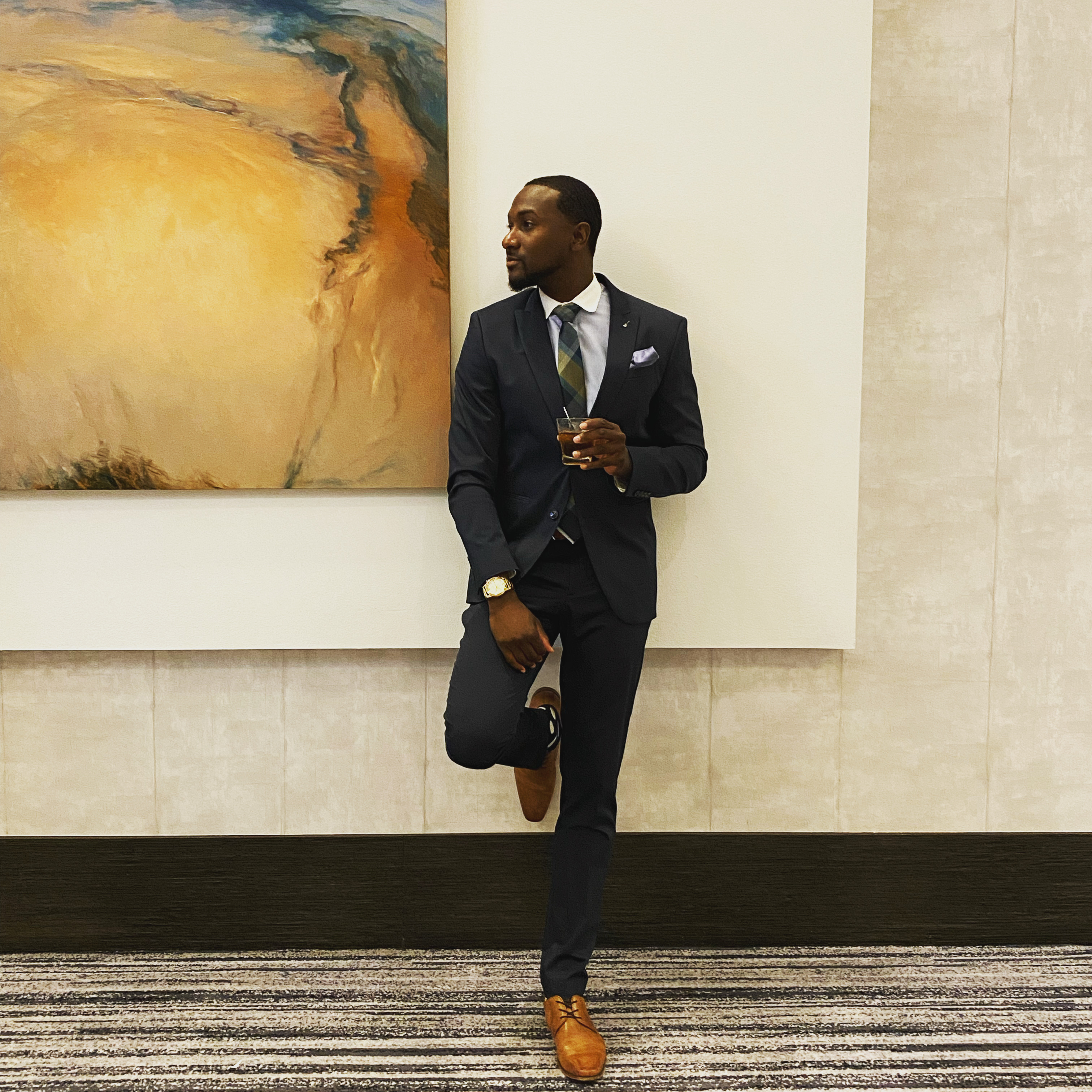 James Houston in tailored suiting at an upscale venue.