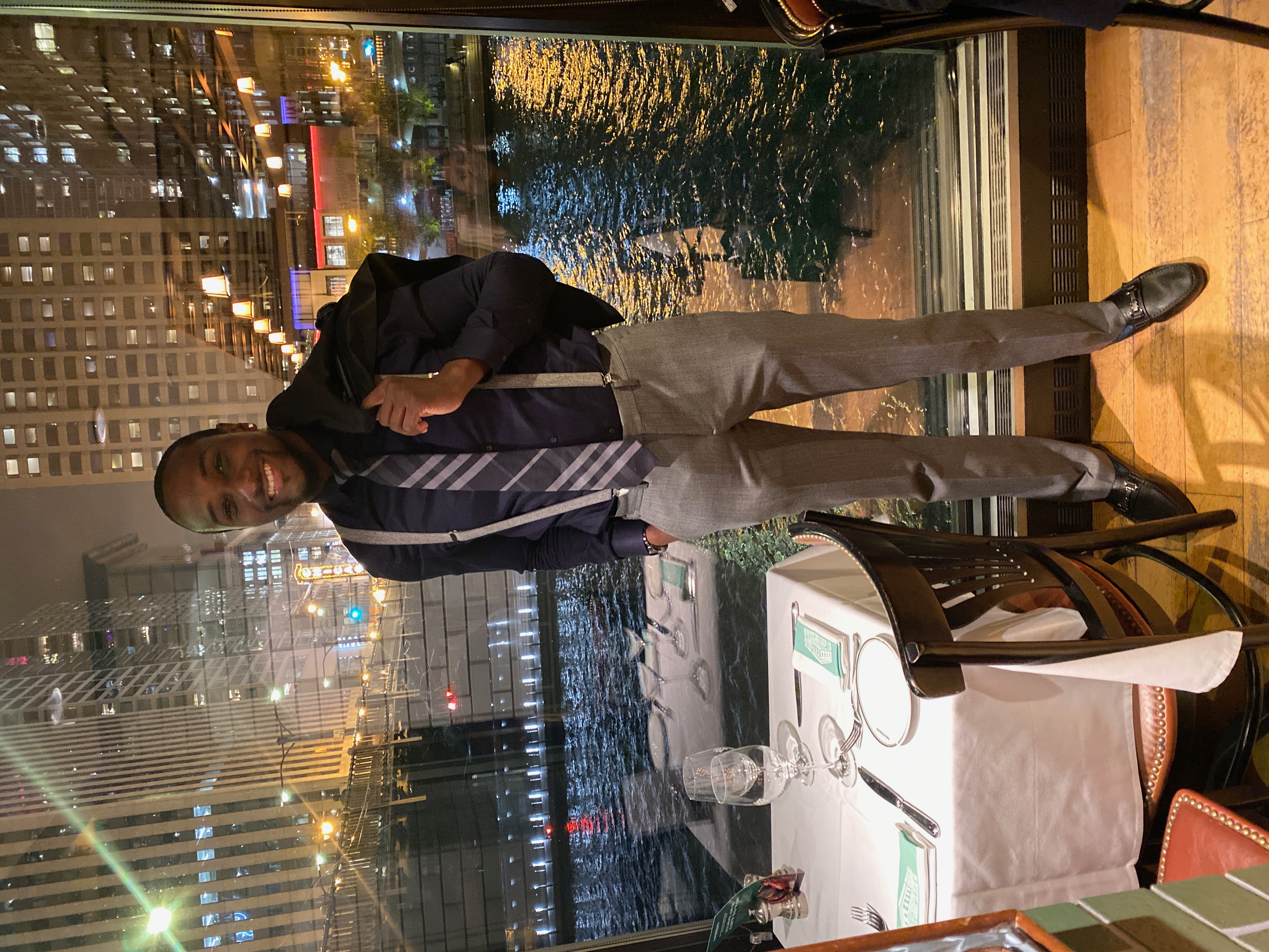 James Houston dressed for an evening dinner with a city backdrop.